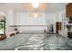 Spacious kitchen featuring a large island with marble countertops, a sink, and seating for five at 5102 Chastleton Dr, Stone Mountain, GA 30087