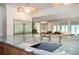 Spacious kitchen island with a gray marble countertop, a sink, and seating overlooking the backyard at 5102 Chastleton Dr, Stone Mountain, GA 30087