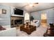 Cozy living room featuring a stone fireplace, plush seating, and soft lighting for ultimate relaxation and comfort at 5102 Chastleton Dr, Stone Mountain, GA 30087