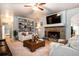 A comfy living room with a stone fireplace and custom built-in shelving, perfect for entertaining and relaxation at 5102 Chastleton Dr, Stone Mountain, GA 30087