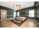 Spacious main bedroom with hardwood floors, ceiling fan, and walk-in closet at 5102 Chastleton Dr, Stone Mountain, GA 30087