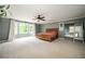 Spacious main bedroom with carpet, a ceiling fan, and a large bay window at 5102 Chastleton Dr, Stone Mountain, GA 30087