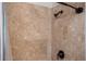 Close-up of a tiled shower with bronze fixtures at 5102 Chastleton Dr, Stone Mountain, GA 30087