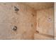 Walk-in shower with travertine tile, dual showerheads, and a built-in bench at 5102 Chastleton Dr, Stone Mountain, GA 30087