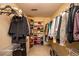 Walk-in closet with ample shelving and hanging space for clothes and accessories at 5102 Chastleton Dr, Stone Mountain, GA 30087