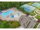 Stunning aerial view of community pool, tennis courts, playground and clubhouse surrounded by lush greenery at 5880 Crestwick Way, Cumming, GA 30040