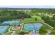 Aerial view of community sports courts including tennis, basketball, playground, and picnic areas surrounded by woods at 5880 Crestwick Way, Cumming, GA 30040