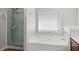 Bathroom features a glass enclosed shower and a large soaking tub at 5880 Crestwick Way, Cumming, GA 30040