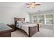 Comfortable bedroom with ceiling fan, large windows, and neutral decor at 5880 Crestwick Way, Cumming, GA 30040