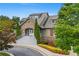 Community clubhouse entrance with stone accents, well-manicured landscaping, and inviting staircase at 5880 Crestwick Way, Cumming, GA 30040