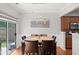 Elegant dining room with modern lighting and a sliding glass door to the outdoors at 5880 Crestwick Way, Cumming, GA 30040