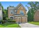 Charming two-story home featuring a well-manicured lawn and a two-car garage at 5880 Crestwick Way, Cumming, GA 30040