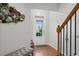 Bright foyer with wood floors, staircase, and decorative wall art at 5880 Crestwick Way, Cumming, GA 30040