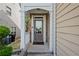 Inviting front entrance with a covered porch and classic door at 5880 Crestwick Way, Cumming, GA 30040