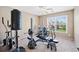 Home gym features various exercise machines and free weights at 5880 Crestwick Way, Cumming, GA 30040