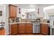 Spacious kitchen with granite countertops and stainless steel dishwasher at 5880 Crestwick Way, Cumming, GA 30040