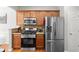 Well-equipped kitchen with stainless steel appliances and warm wood cabinets at 5880 Crestwick Way, Cumming, GA 30040
