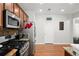 Updated kitchen with gas range, stainless steel appliances, and hardwood floors at 5880 Crestwick Way, Cumming, GA 30040