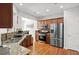 Open kitchen layout with modern stainless steel appliances and bright lighting at 5880 Crestwick Way, Cumming, GA 30040