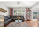 Comfortable living room with a plush sectional, modern ceiling fan, and ample natural light at 5880 Crestwick Way, Cumming, GA 30040
