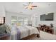 Bright main bedroom with vaulted ceiling, TV, and large windows at 5880 Crestwick Way, Cumming, GA 30040