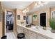 Bathroom featuring double sinks and vanity with an open door to another room at 2502 Oak Hill Ovlk, Duluth, GA 30097