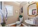 Traditional bathroom with a classic vanity, decorative mirror, and ample natural light at 2502 Oak Hill Ovlk, Duluth, GA 30097