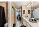 Bathroom with double sinks and an open doorway to another bedroom at 2502 Oak Hill Ovlk, Duluth, GA 30097