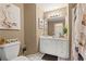 Bathroom featuring a vanity, mirror, decorative lighting, and artwork at 2502 Oak Hill Ovlk, Duluth, GA 30097