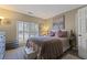 Cozy bedroom featuring neutral tones, plush bedding, and window shutters at 2502 Oak Hill Ovlk, Duluth, GA 30097
