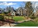 Two story home with mature landscaping, stone facade, well manicured lawn and a wooden walkway at 2502 Oak Hill Ovlk, Duluth, GA 30097