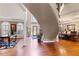 Elegant foyer showcasing a curved staircase, hardwood floors, and views of the dining area at 2502 Oak Hill Ovlk, Duluth, GA 30097