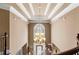 Bright foyer featuring a stunning chandelier, tray ceiling, and staircase at 2502 Oak Hill Ovlk, Duluth, GA 30097