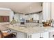 Well-lit kitchen boasts granite countertops, modern appliances, and custom cabinetry for ample storage at 2502 Oak Hill Ovlk, Duluth, GA 30097