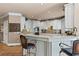 Traditional-style kitchen with white cabinets, granite countertops, and barstool seating at the kitchen island at 2502 Oak Hill Ovlk, Duluth, GA 30097