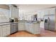 Spacious kitchen offering stainless steel appliances, tile floors, and granite countertops at 2502 Oak Hill Ovlk, Duluth, GA 30097