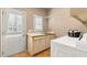 Functional laundry room with washer, dryer, utility sink, and plenty of natural light at 2502 Oak Hill Ovlk, Duluth, GA 30097