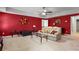 Spacious living room with red accent wall, plush sofa, and glass coffee table at 2502 Oak Hill Ovlk, Duluth, GA 30097