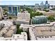 Overhead shot of condo complex with parking, located in an urban area with surrounding city skyline at 395 Pharr Ne Rd # 103, Atlanta, GA 30305