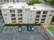 Aerial view of a multi-story building featuring multiple balconies, parking area, and green spaces at 395 Pharr Ne Rd # 103, Atlanta, GA 30305