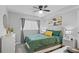 Cozy bedroom with ceiling fan, stylish decor, and a comfortable bed with throw pillows at 395 Pharr Ne Rd # 103, Atlanta, GA 30305