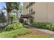 Beautiful building entrance with lush landscaping and covered entryway, showcasing the inviting curb appeal at 395 Pharr Ne Rd # 103, Atlanta, GA 30305