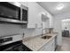 Updated kitchen with stainless steel microwave, range, and white cabinets at 395 Pharr Ne Rd # 103, Atlanta, GA 30305