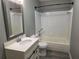 Bathroom featuring a tub/shower combo, new vanity, and gray walls at 5818 Par Four Ct, Lithonia, GA 30038