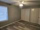 Bedroom featuring wood-look floors, neutral walls, a ceiling fan, and double closets at 5818 Par Four Ct, Lithonia, GA 30038