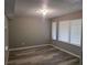 Living room featuring newly installed wood-look flooring, neutral paint, and modern window treatments at 5818 Par Four Ct, Lithonia, GA 30038