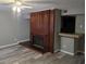 Living room featuring a rustic-style fireplace and bar area with modern grey walls and flooring at 5818 Par Four Ct, Lithonia, GA 30038