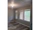 Living room showcasing large windows, modern gray walls, and wood-look floors at 5818 Par Four Ct, Lithonia, GA 30038