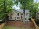 Two-story brick home with a large treed yard and a wood fence at 833 Martina Ne Dr, Atlanta, GA 30305