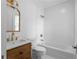 Bathroom featuring marble vanity, vintage gold accents, and white subway tile in shower and tub at 833 Martina Ne Dr, Atlanta, GA 30305
